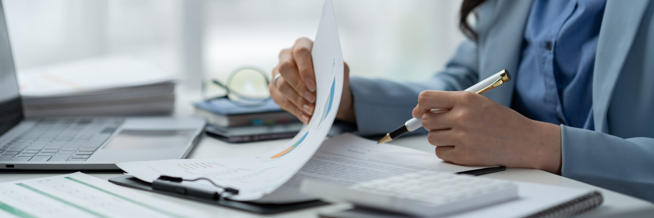 Title company professional reviewing outsourced title search reports on a desktop dashboard